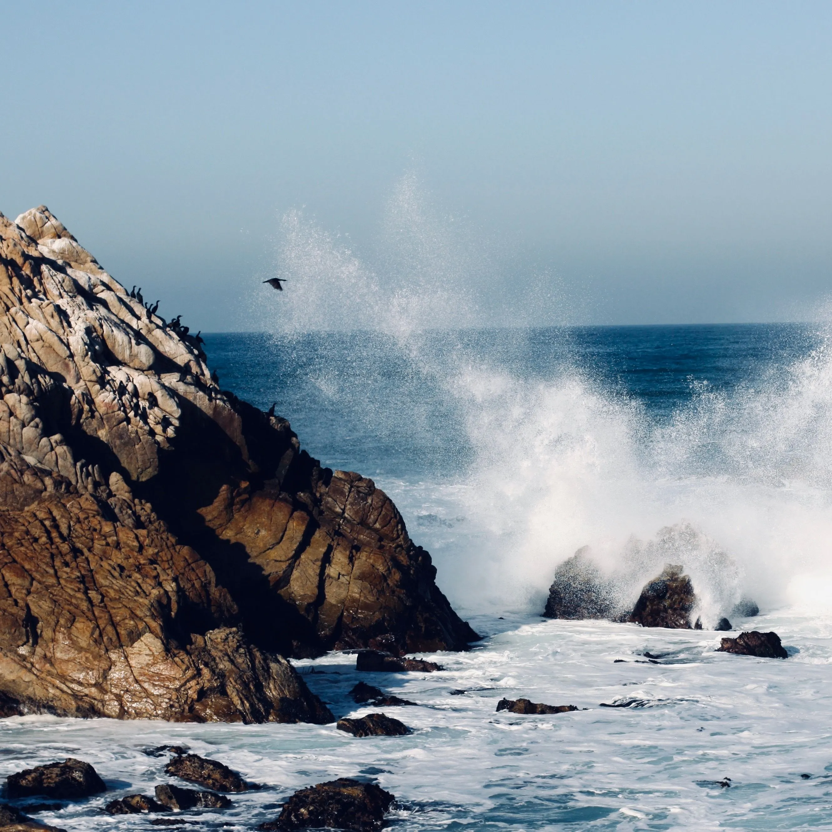 Ocean waves crashing against rocky coastline