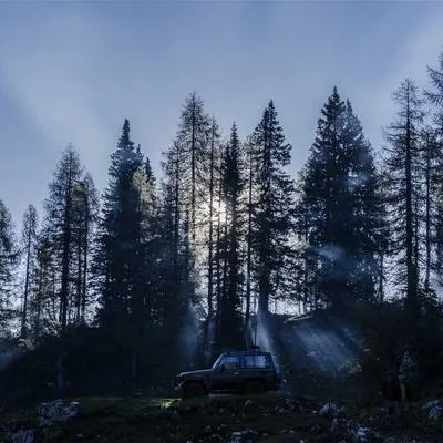 Starry night sky over a mountain silhouette